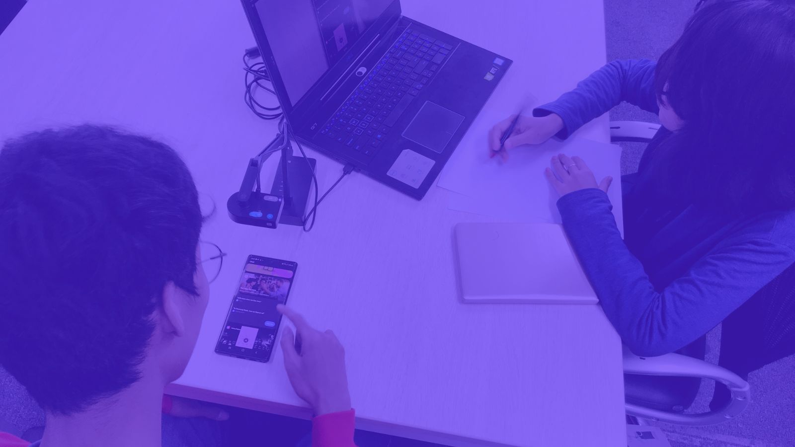 Two employees testing a web app